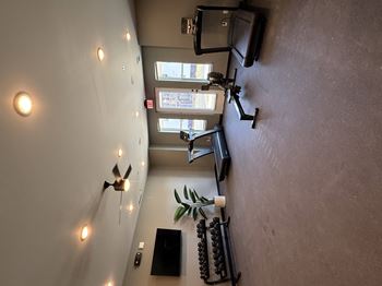 A room with a wall of lights and a flat screen TV.